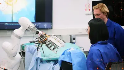 Researchers working with a KUKA robotic arm.