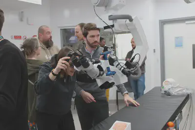 A patient representative manipulating a surgical microscope featuring our hyperspectral imaging technology for neurosurgery.