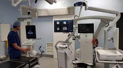 A simulated navigated neurosurgery in a mock operating room. The project aims at replacing the complex marker-based neuronavigation system by a marker-free approach for external ventricular drain (EVD) placement.